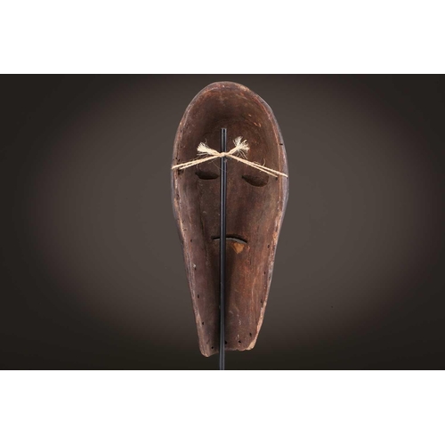 118 - A Lombi mask, Democratic Republic of Congo, the eye sockets painted with thick white pigment, 40cm, ... 
