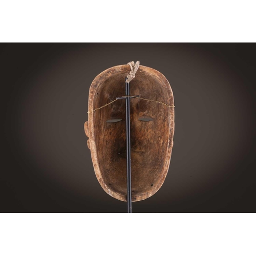 118 - A Lombi mask, Democratic Republic of Congo, the eye sockets painted with thick white pigment, 40cm, ... 