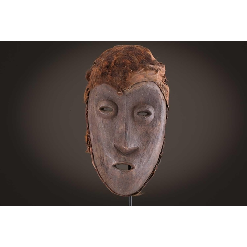 118 - A Lombi mask, Democratic Republic of Congo, the eye sockets painted with thick white pigment, 40cm, ... 