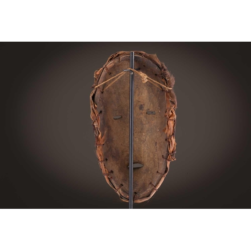 118 - A Lombi mask, Democratic Republic of Congo, the eye sockets painted with thick white pigment, 40cm, ... 