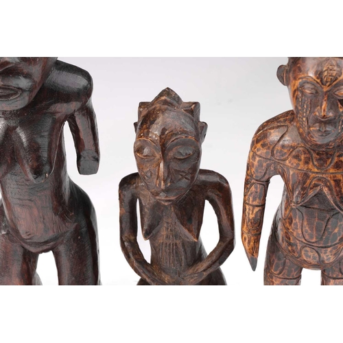 20 - A Dogon hemaphroditic standing figure, Mali, 38cm; two further Dogon female figures, one with horns ... 