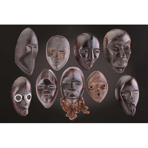 65 - A group of nine Dan masks, Liberia, to include two bird masks and three passport masks, 12.5cm - 32c... 