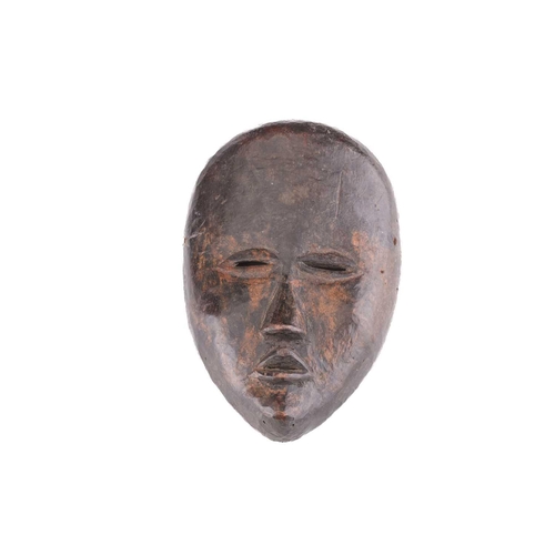 65 - A group of nine Dan masks, Liberia, to include two bird masks and three passport masks, 12.5cm - 32c... 