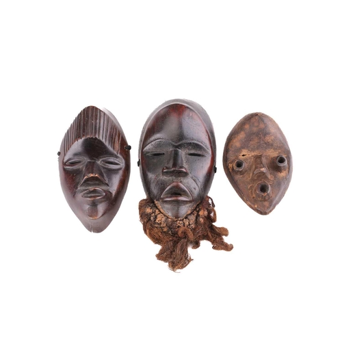 65 - A group of nine Dan masks, Liberia, to include two bird masks and three passport masks, 12.5cm - 32c... 