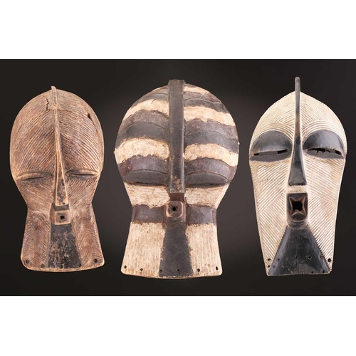 68 - Three Luba kifwebe, Democratic Republic of Congo, with incised linear decoration, painted in black &... 