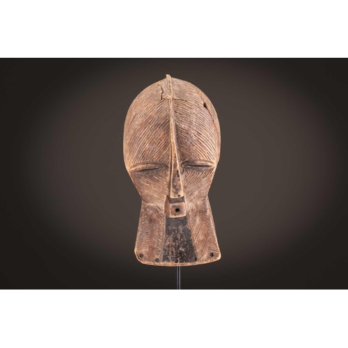 68 - Three Luba kifwebe, Democratic Republic of Congo, with incised linear decoration, painted in black &... 