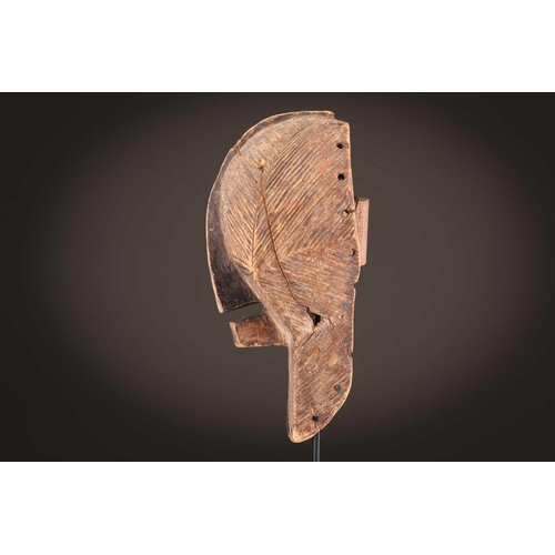 68 - Three Luba kifwebe, Democratic Republic of Congo, with incised linear decoration, painted in black &... 