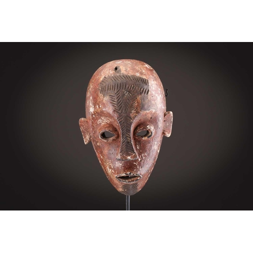 74 - A Ngbaka mask, Democratic Republic of Congo,the hollowed eye sockets painted red & white, the red ey... 