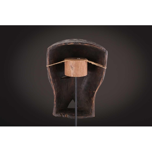 74 - A Ngbaka mask, Democratic Republic of Congo,the hollowed eye sockets painted red & white, the red ey... 