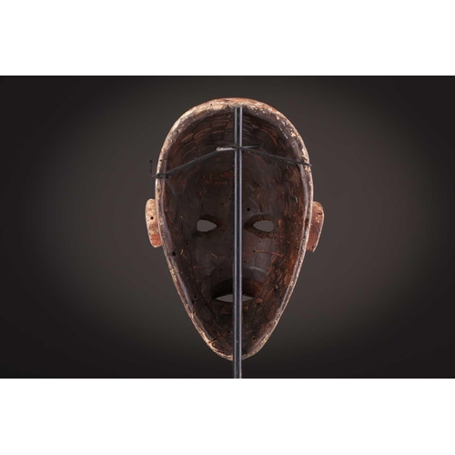 74 - A Ngbaka mask, Democratic Republic of Congo,the hollowed eye sockets painted red & white, the red ey... 