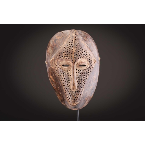 74 - A Ngbaka mask, Democratic Republic of Congo,the hollowed eye sockets painted red & white, the red ey... 