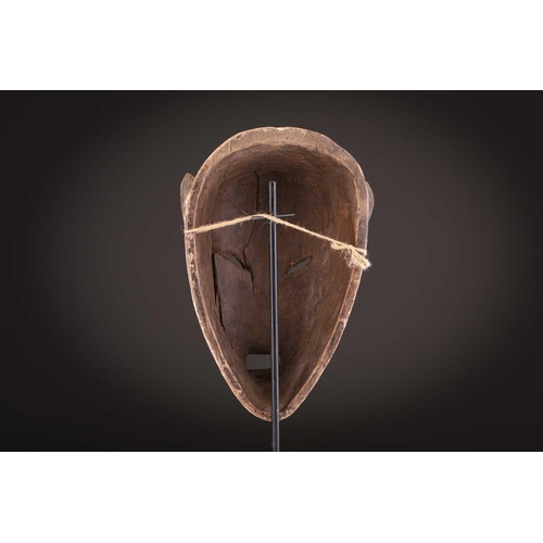 74 - A Ngbaka mask, Democratic Republic of Congo,the hollowed eye sockets painted red & white, the red ey... 