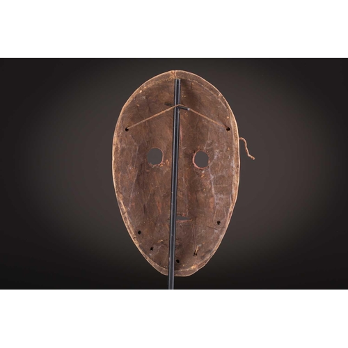 74 - A Ngbaka mask, Democratic Republic of Congo,the hollowed eye sockets painted red & white, the red ey... 