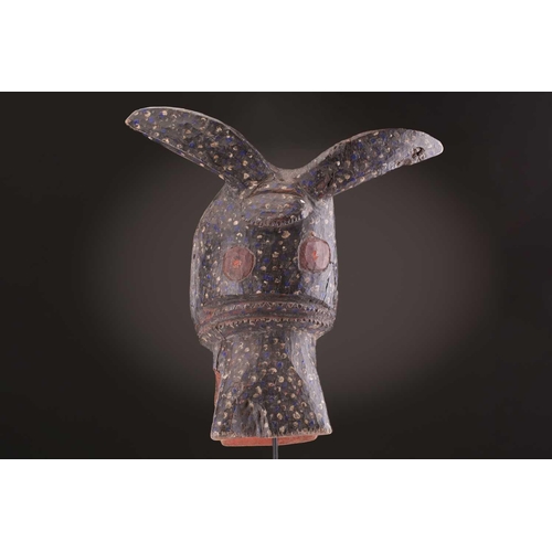 75 - A Mambila zoomorphic mask, Nigeria, painted with blue and white spots on a black ground, the mouth a... 