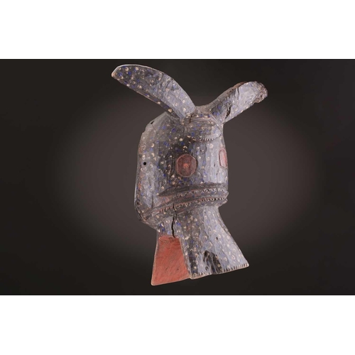 75 - A Mambila zoomorphic mask, Nigeria, painted with blue and white spots on a black ground, the mouth a... 