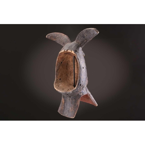 75 - A Mambila zoomorphic mask, Nigeria, painted with blue and white spots on a black ground, the mouth a... 