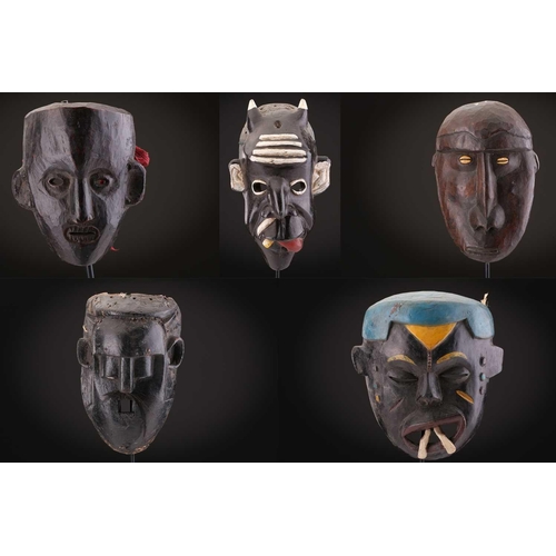 78 - Two Indonesian sickness type masks, painted in colours, 31cm & 32cm, two further masks, 20.5cm - 35c... 