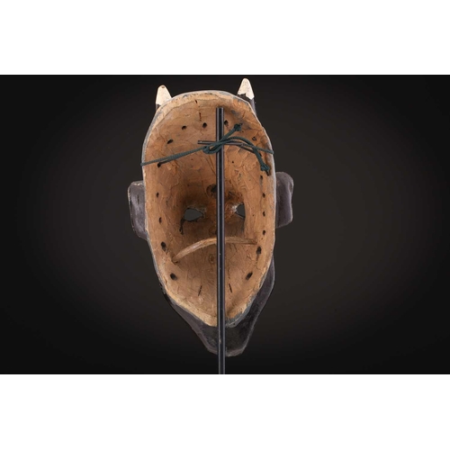 78 - Two Indonesian sickness type masks, painted in colours, 31cm & 32cm, two further masks, 20.5cm - 35c... 