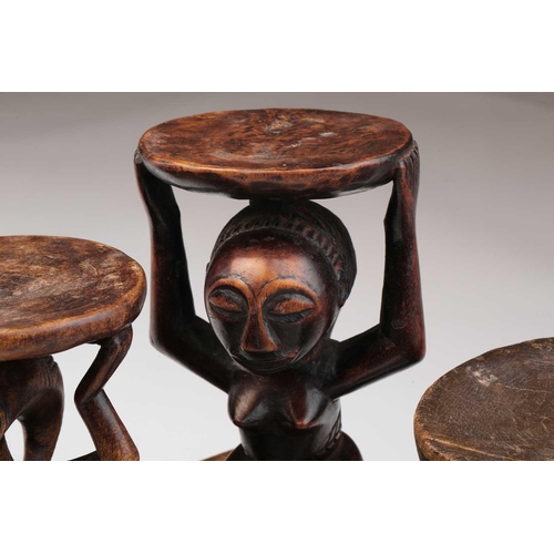 79 - A small Luba Hemba double caryatid stool, Democratic Republic of Congo, the oval top above a seated ... 