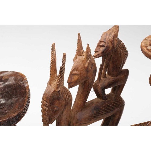 79 - A small Luba Hemba double caryatid stool, Democratic Republic of Congo, the oval top above a seated ... 