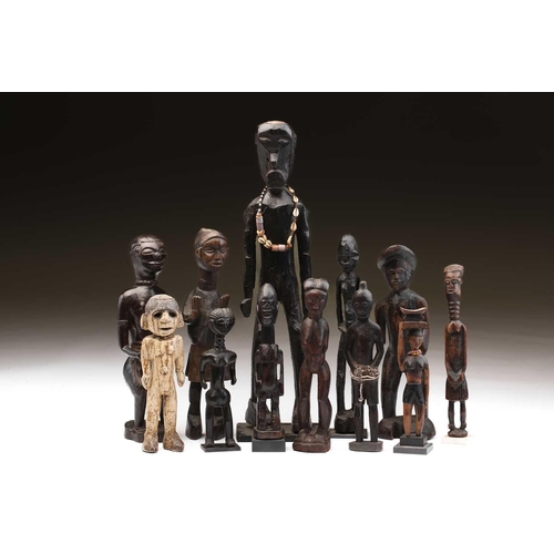 80 - A collection of twelve principally West African standing male and female figures, to include Agni, A... 