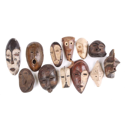 81 - A collection of twelve West Africa passport type masks, to include Songye, a Lega hand held Lukwakon... 
