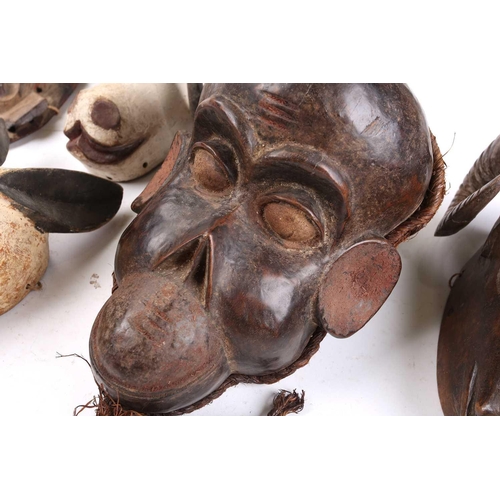 82 - A collection of zoomorphic masks, to include a Luba boar and ram, a Pende horned beast, painted with... 