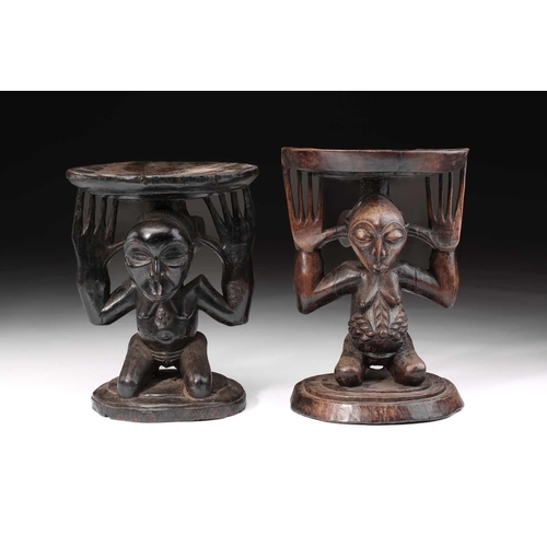 85 - Two Luba female caryatid stools, Democratic Republic of Congo, carved kneeling and supporting a circ... 