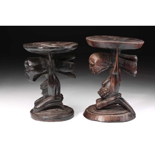 85 - Two Luba female caryatid stools, Democratic Republic of Congo, carved kneeling and supporting a circ... 