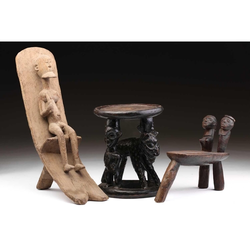 86 - A Bamileke stool, Cameroon, the circular top supported by two male figures flanking a leopard, colou... 