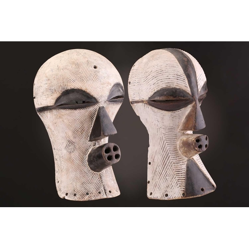 90 - Two Songye/Luba female Bifwebe masks, Bikashi, each with fine linear decoration, the eyes, nose and ... 