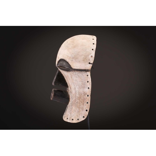 90 - Two Songye/Luba female Bifwebe masks, Bikashi, each with fine linear decoration, the eyes, nose and ... 