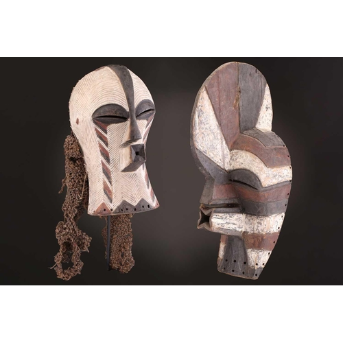 91 - Two Songye kifwebe, Democratic Republic of Congo, the male mask with a tall crest, with butterfly sh... 