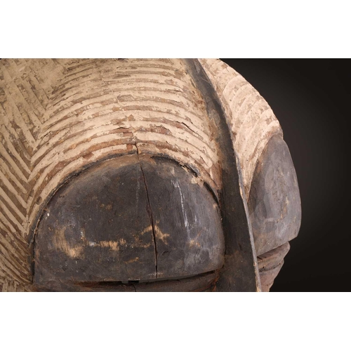 94 - Two Songye Bilume Kifwebe, Democratic Republic of Congo, each with a short pointed crest and oversiz... 