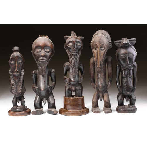 95 - A group of Hemba standing male figures, Democratic Republic of Congo, three with long linear carved ... 