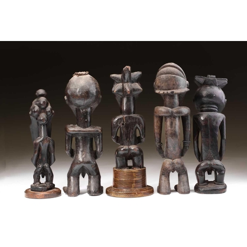 95 - A group of Hemba standing male figures, Democratic Republic of Congo, three with long linear carved ... 
