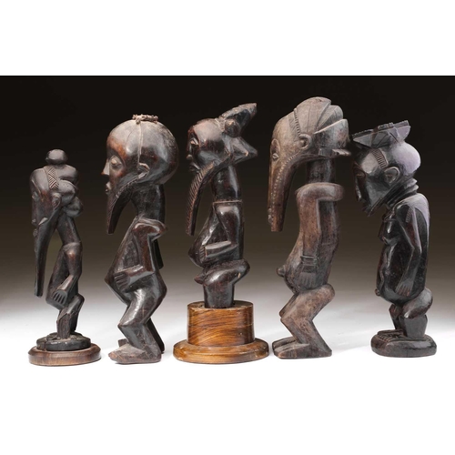 95 - A group of Hemba standing male figures, Democratic Republic of Congo, three with long linear carved ... 