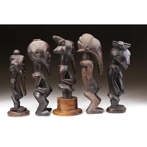 95 - A group of Hemba standing male figures, Democratic Republic of Congo, three with long linear carved ... 