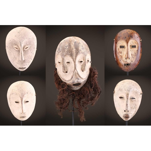 96 - A group of five Lega Idimu masks, Democratic Republic of Congo, painted white with pierced sides, to... 