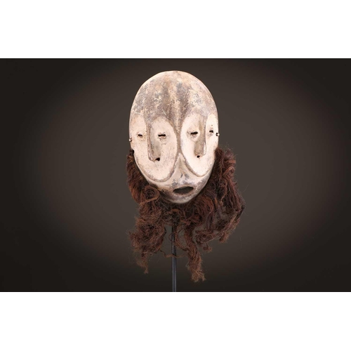96 - A group of five Lega Idimu masks, Democratic Republic of Congo, painted white with pierced sides, to... 