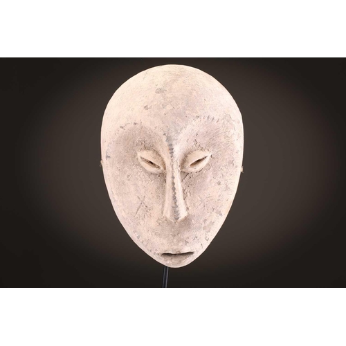 96 - A group of five Lega Idimu masks, Democratic Republic of Congo, painted white with pierced sides, to... 