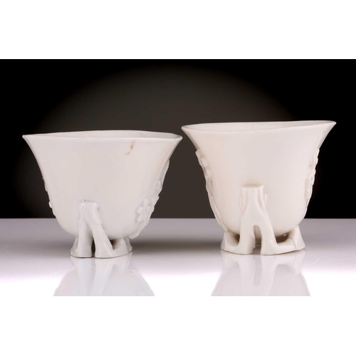 104 - Two Chinese Dehua blanc de chine libation cups, Qing dynasty, 18th century, each with applied sprrig... 