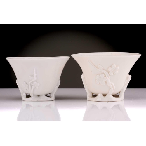 104 - Two Chinese Dehua blanc de chine libation cups, Qing dynasty, 18th century, each with applied sprrig... 