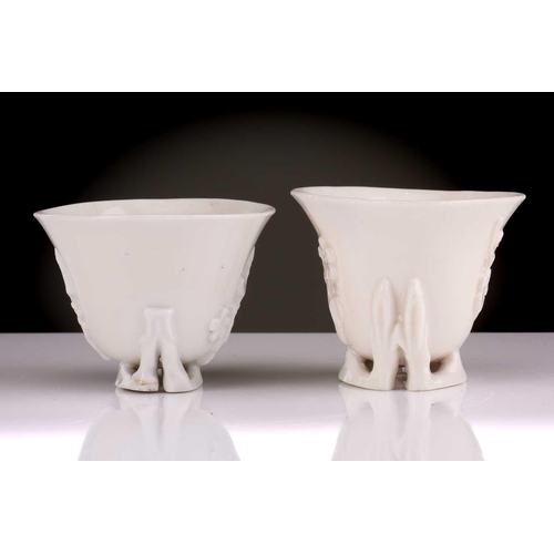 104 - Two Chinese Dehua blanc de chine libation cups, Qing dynasty, 18th century, each with applied sprrig... 