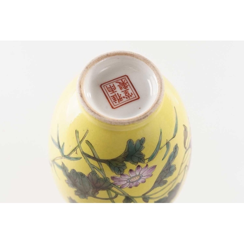 111 - A pair of small Chinese yellow ground vases, ya yu tang, decorated with flowering blooms and butterf... 