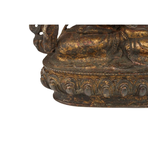 115 - A Chinese Sino Tibetan style bronze Tara, seated in dhyanasana, the six arms with attributes, traces... 