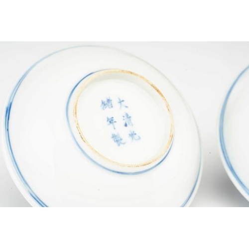 119 - A pair of Chinese porcelain Wufu dishes, 20th century, painted with five red bats flying amongst blu... 