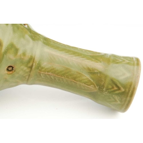 158 - A Chinese celadon double wall pierced vase, the neck with moulded banana leaves above the pierced bo... 