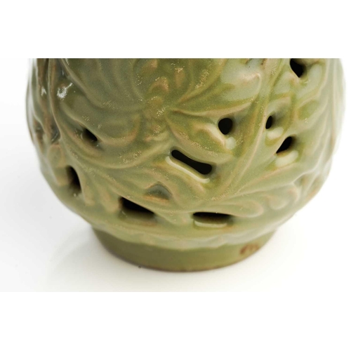 158 - A Chinese celadon double wall pierced vase, the neck with moulded banana leaves above the pierced bo... 