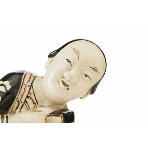 160 - A Chinese Cizhou figural pillow, Song dynasty or later, modelled as a recumbent female, wearing a bl... 